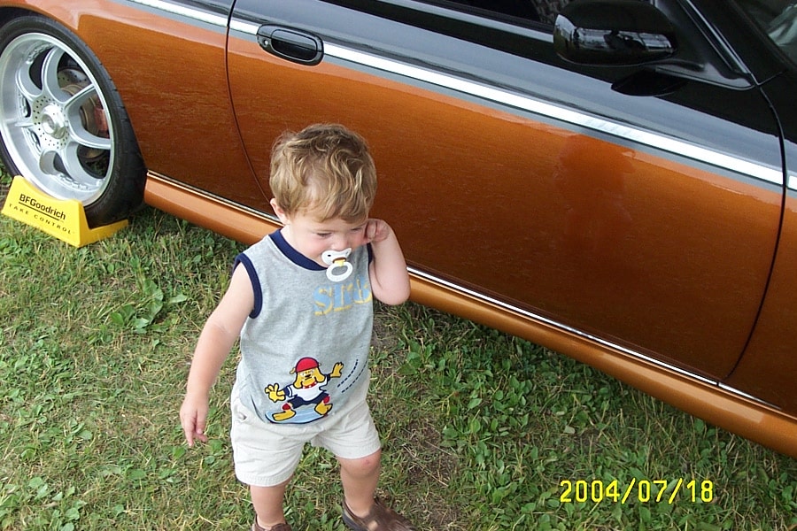 Family at a car show — our children grew up alongside the business